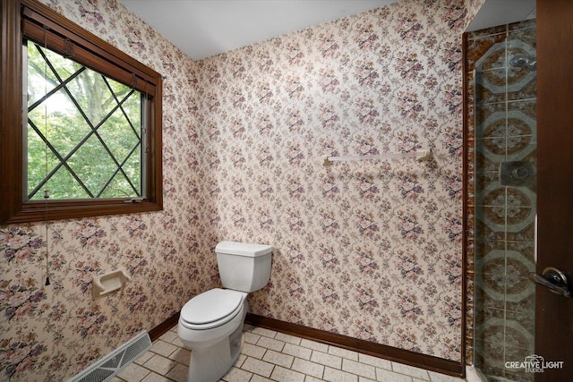 42W325 Jens Jensen Ln, Saint Charles, IL 60175 - bathroom featuring a stall shower, toilet, tile patterned floors, and baseboards