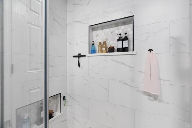 full bathroom with tiled shower