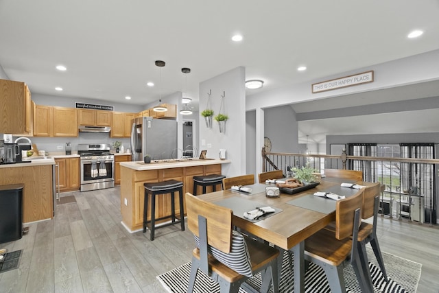 dining room with light wood-type flooring and recessed lighting