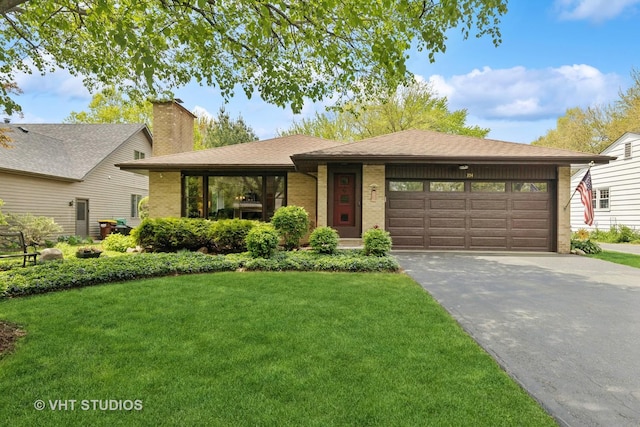 354 Richmond Ln, Lakewood, IL 60014 - single story home with asphalt driveway, a front lawn, brick siding, a garage, and a chimney