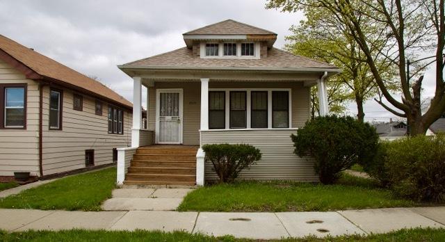 bungalow-style home featuring a porch and roof with shingles