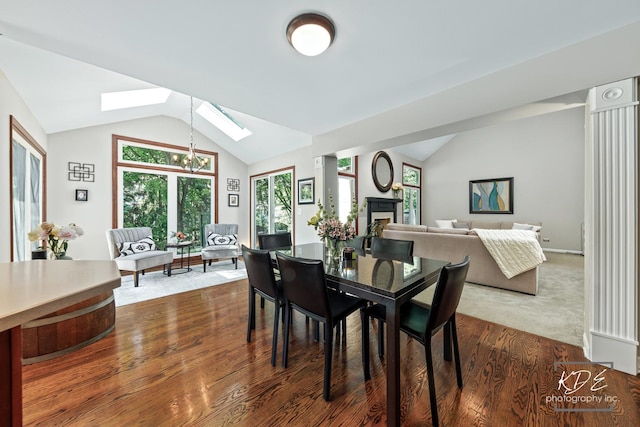 480 De Lasalle Ave, Naperville, IL 60565 - dining area with vaulted ceiling, a skylight, dark wood-style flooring, a fireplace, and plenty of natural light