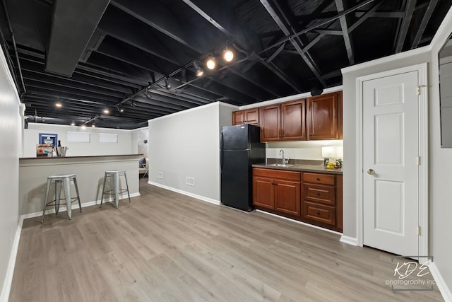 480 De Lasalle Ave, Naperville, IL 60565 - kitchen featuring freestanding refrigerator, a sink, light wood-style floors, brown cabinetry, and dark countertops