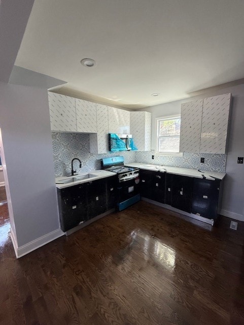 7 W 112th Pl, Chicago, IL 60628 - kitchen featuring gas range oven, dark cabinetry, a sink, and light countertops