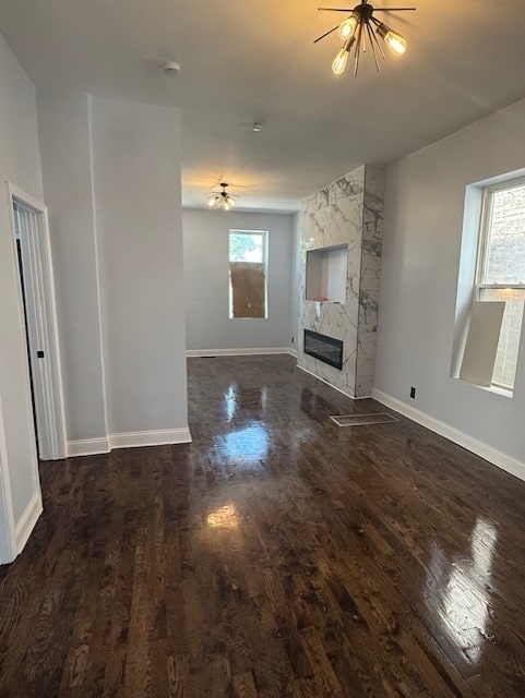 7 W 112th Pl, Chicago, IL 60628 - unfurnished living room with wood finished floors, a tile fireplace, baseboards, and a ceiling fan