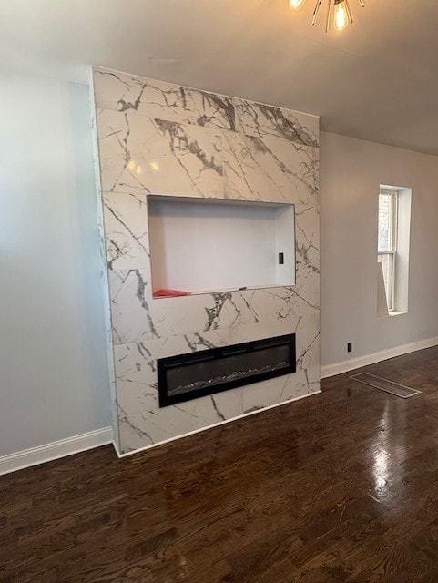 7 W 112th Pl, Chicago, IL 60628 - detailed view of a fireplace, baseboards, and wood finished floors