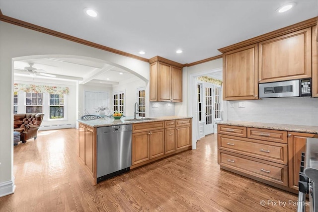 705 Hunter Rd, Glenview, IL 60025 - kitchen with appliances with stainless steel finishes, arched walkways, a sink, baseboard heating, and light wood-type flooring