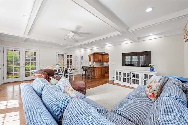 705 Hunter Rd, Glenview, IL 60025 - living room with french doors, arched walkways, light wood-style floors, coffered ceiling, and a ceiling fan