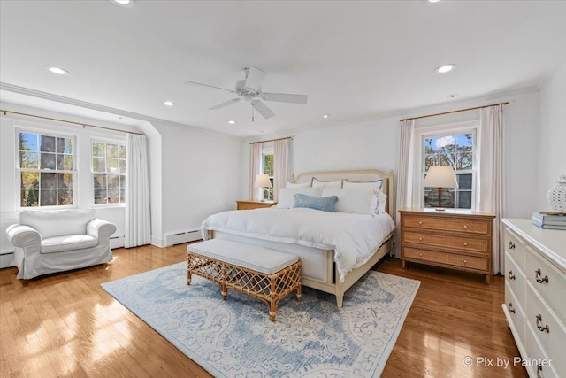 705 Hunter Rd, Glenview, IL 60025 - bedroom featuring a baseboard radiator, multiple windows, wood finished floors, and recessed lighting