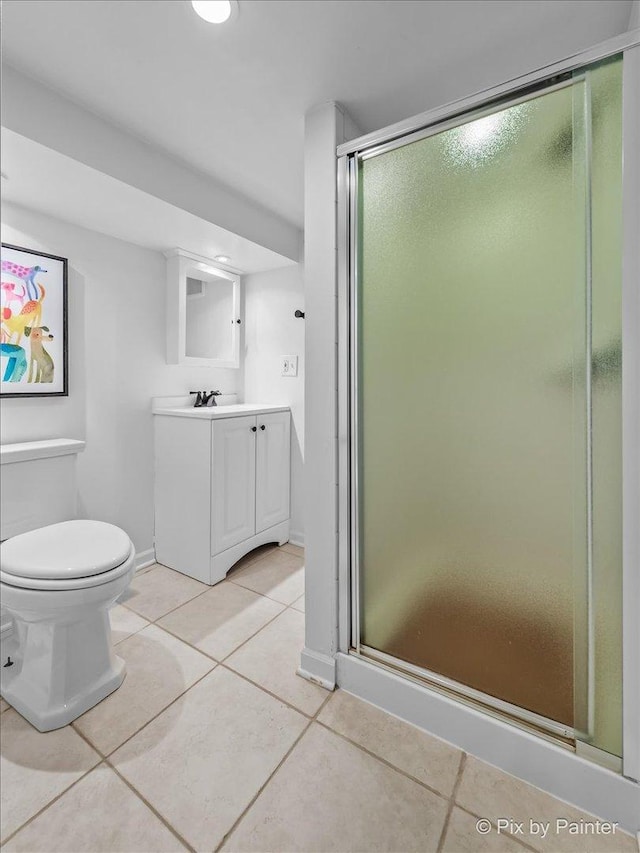 705 Hunter Rd, Glenview, IL 60025 - bathroom featuring tile patterned floors, vanity, a stall shower, and toilet