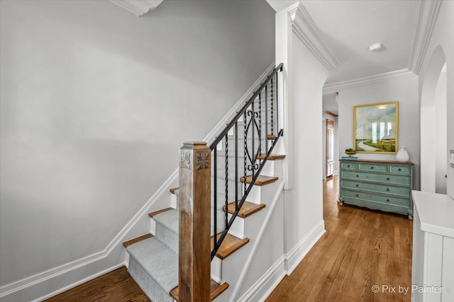 705 Hunter Rd, Glenview, IL 60025 - stairs featuring arched walkways, wood finished floors, ornamental molding, and baseboards