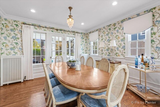 705 Hunter Rd, Glenview, IL 60025 - dining space with ornamental molding, wallpapered walls, wainscoting, wood finished floors, and radiator heating unit