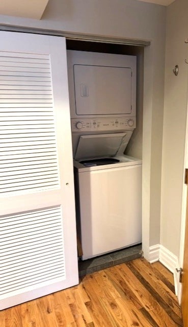 5611 N Glenwood Ave Unit G, Chicago, IL 60660 - washroom with stacked washer and clothes dryer and wood finished floors