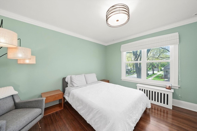 bedroom featuring radiator heating unit, ornamental molding, wood finished floors, and baseboards
