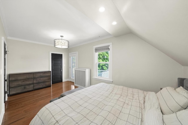 bedroom with wood finished floors, recessed lighting, vaulted ceiling, baseboards, and ornamental molding