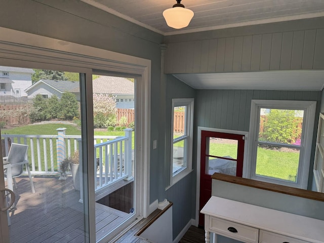 doorway to outside featuring crown molding