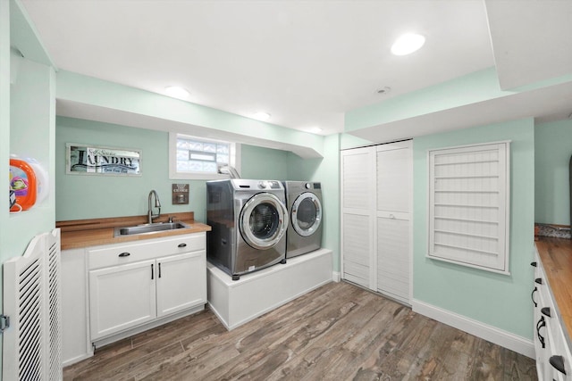 washroom featuring washing machine and clothes dryer and wood finished floors