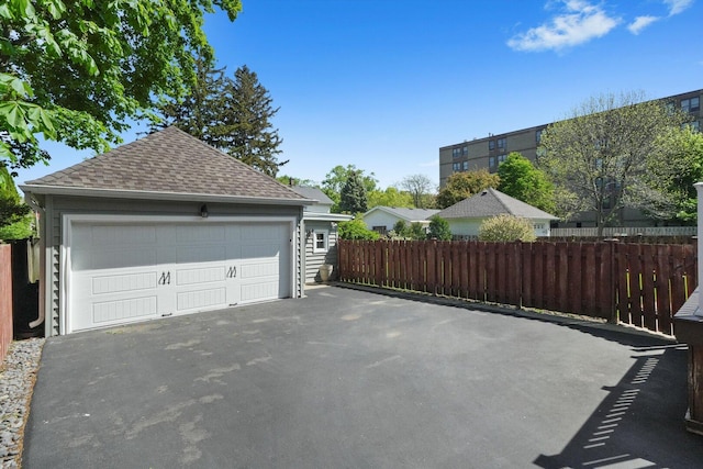 detached garage featuring fence