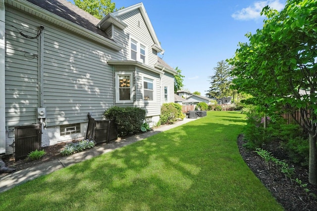 view of green lawn with central AC