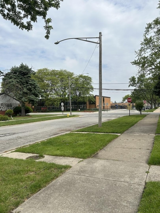 12509 S Bishop St, Calumet Park, IL 60827 - view of asphalt road featuring sidewalks, traffic signs, and street lighting