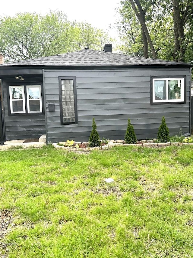 12509 S Bishop St, Calumet Park, IL 60827 - view of home's exterior with a chimney, a yard, and roof with shingles