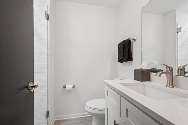 full bathroom with toilet, vanity, a shower, baseboards, and tile patterned flooring