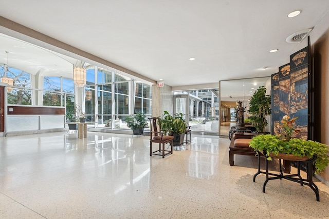 building lobby featuring floor to ceiling windows and recessed lighting