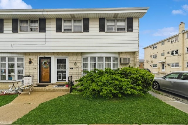 6555 W Addison St Unit A, Chicago, IL 60634 - view of front of home featuring brick siding and a front lawn
