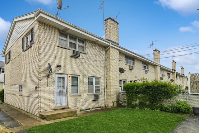 6555 W Addison St Unit A, Chicago, IL 60634 - back of property with a chimney, cooling unit, and brick siding