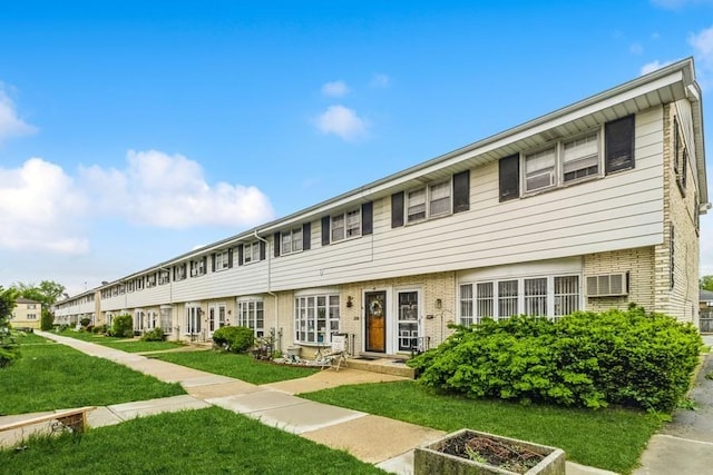 6555 W Addison St Unit A, Chicago, IL 60634 - view of front of property featuring a front yard and brick siding