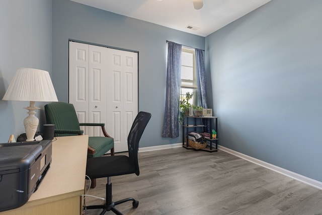 office with wood finished floors, a ceiling fan, and baseboards