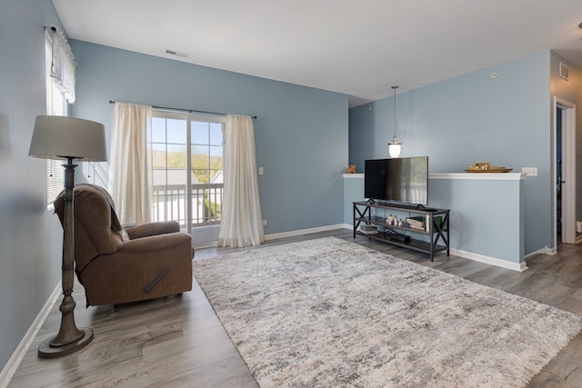 living area featuring wood finished floors and baseboards