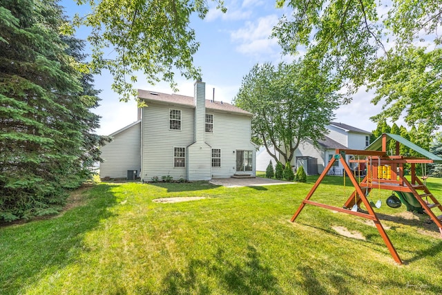 2248 Cheshire Dr, Aurora, IL 60502 - back of property with a playground, a patio area, a chimney, and a yard