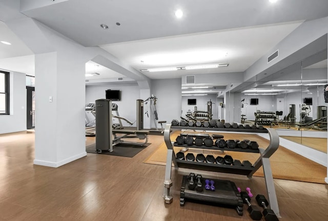 exercise room with wood finished floors