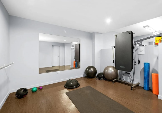 workout area with wood finished floors, baseboards, and recessed lighting