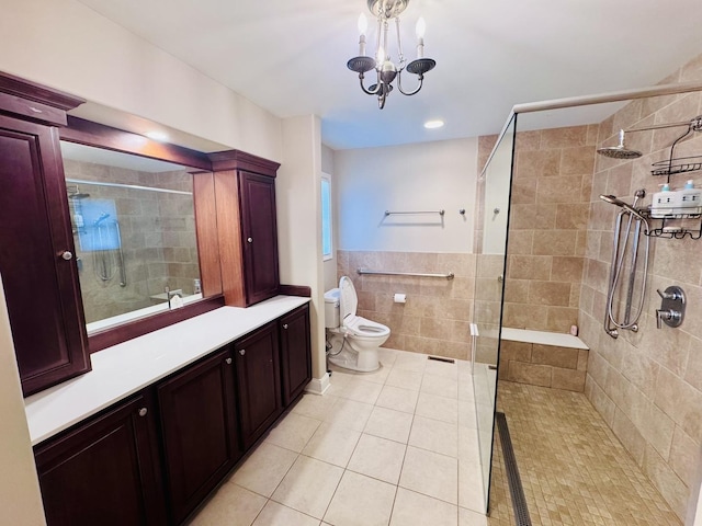 full bath featuring tile patterned flooring, tile walls, a shower stall, toilet, and a chandelier