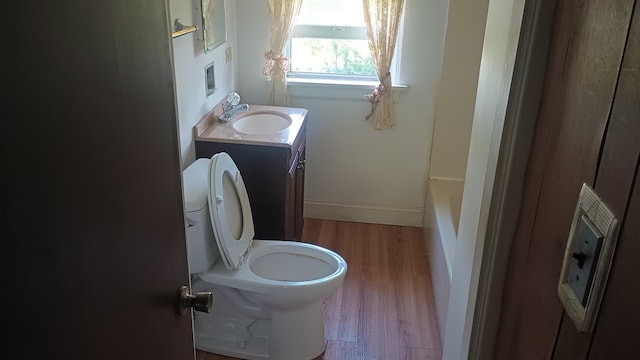 2119 E Exchange St, Crete, IL 60417 - bathroom featuring wood finished floors, toilet, vanity, and a bath