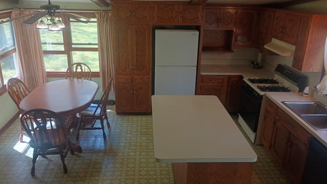 2119 E Exchange St, Crete, IL 60417 - kitchen with freestanding refrigerator, gas range, extractor fan, light flooring, and plenty of natural light