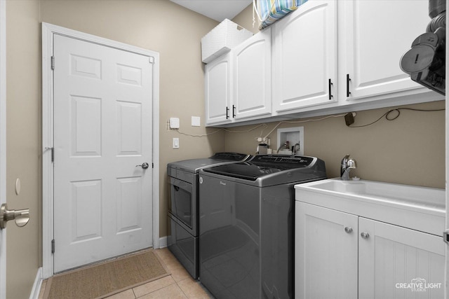 10650 Painted Desert Ct, Huntley, IL 60142 - laundry area with washer and clothes dryer, cabinet space, light tile patterned flooring, and baseboards