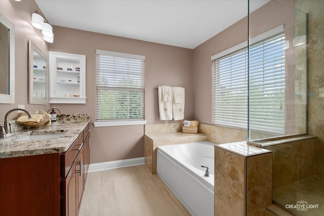 10650 Painted Desert Ct, Huntley, IL 60142 - full bath featuring double vanity, healthy amount of natural light, a bath, and wood finished floors