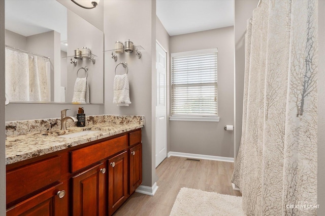 10650 Painted Desert Ct, Huntley, IL 60142 - bathroom with wood finished floors, vanity, and baseboards