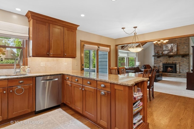 16 Rock River Ct, Naperville, IL 60565 - kitchen featuring dishwasher, a sink, a peninsula, brown cabinets, and light wood-type flooring