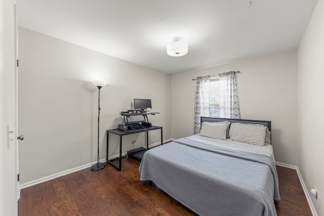 bedroom featuring baseboards and wood finished floors