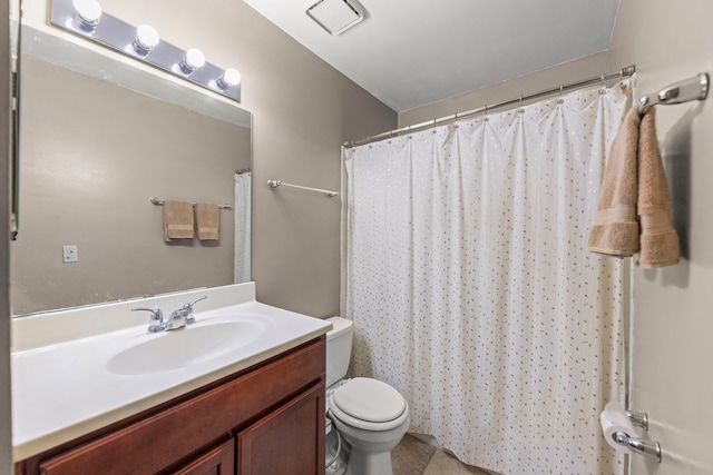 bathroom with toilet, vanity, and a shower with shower curtain