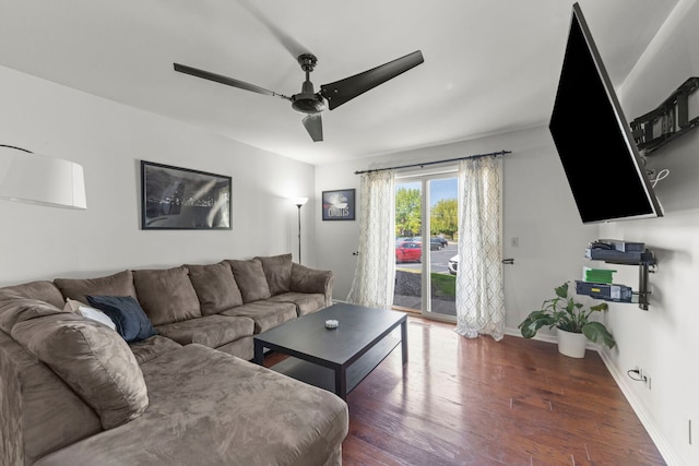 living area featuring wood finished floors, ceiling fan, and baseboards