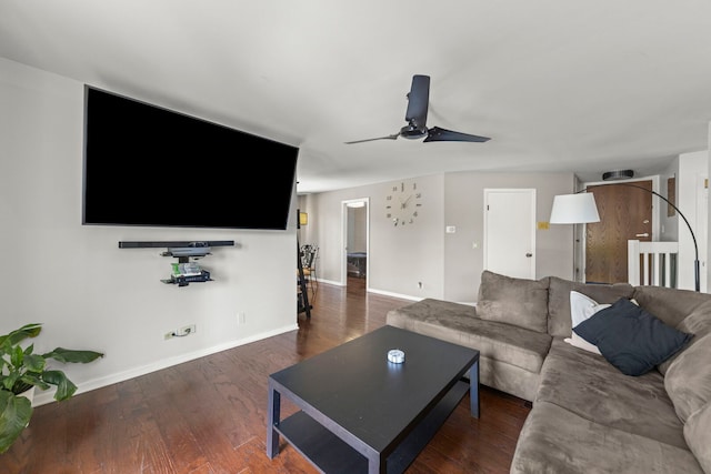 living area featuring ceiling fan, baseboards, and wood finished floors
