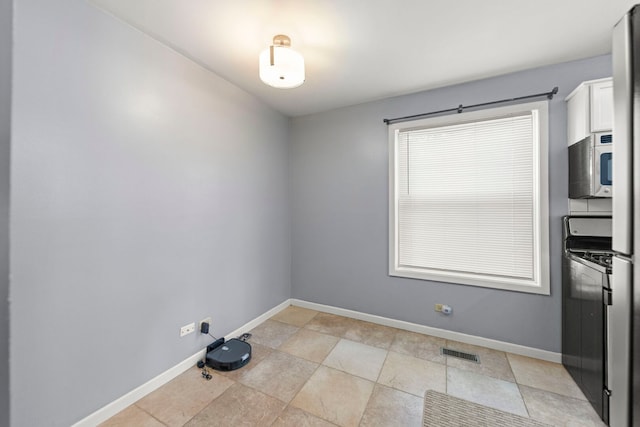 unfurnished dining area with baseboards
