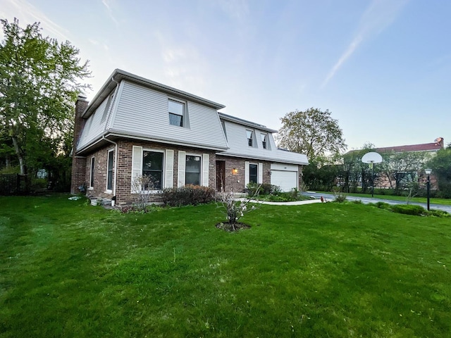 traditional home featuring a chimney, a front yard, brick siding, and a garage