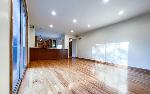 unfurnished living room with light wood finished floors and recessed lighting