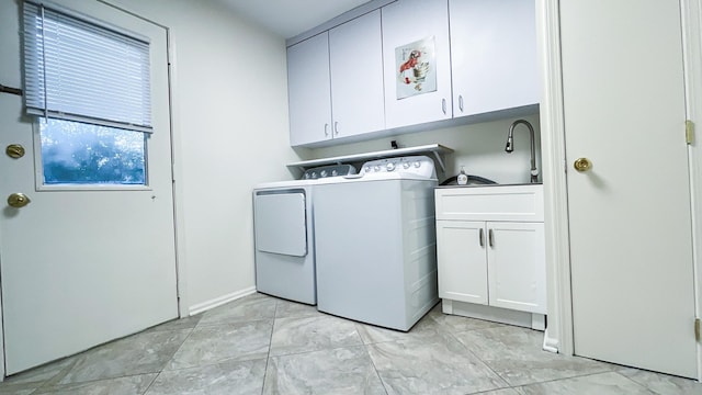 laundry room featuring cabinet space and separate washer and dryer